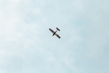 Small propeller aircraft flying in a blue sky