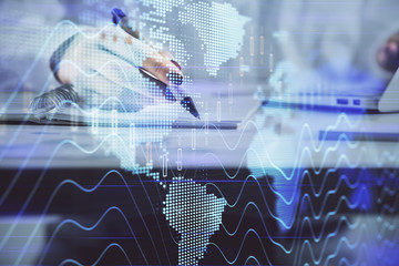 Double exposure of woman's hands making notes with forex graph hologram. Concept technical analysis.