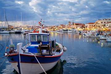 Harbor with leisure and fishing boats at anchor in the evening, Perdika, Egina Island, Greece.