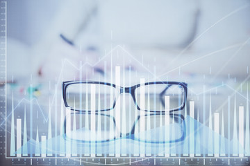 Hand taking notes in notepad. Forex chart holograms in front. Concept of research. Double exposure