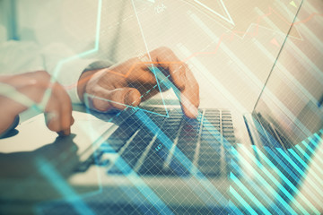 Double exposure of market chart with man working on computer on background. Concept of financial analysis.