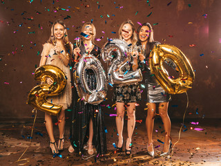 Beautiful Women Celebrating New Year.Happy Gorgeous Girls In Stylish Sexy Party Dresses Holding...