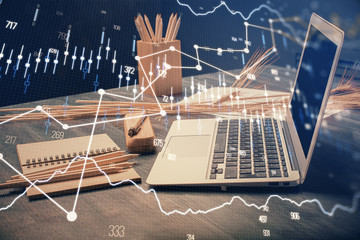 Double exposure of chart and financial info and work space with computer background. Concept of...