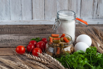 pasta with wheat spikelets on a wooden table