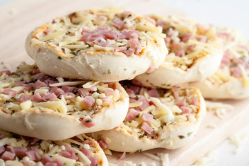 mini pizza sin cocinar de jamón con harina alrededor
