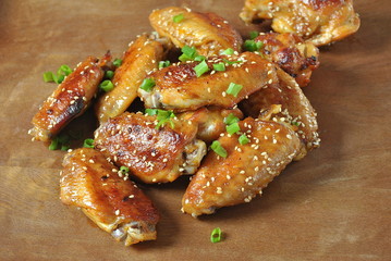 Grilled, barbecue chicken wings, tasty food for dinner or lunch. Fried chicken wings with sesame seeds. Fast food concept