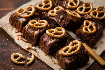 Chocolate brownies with nuts, salted caramel and pretzels