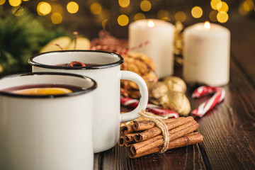 White cups of glint wine on wooden table close up