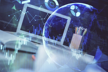 Financial chart drawing and table with computer on background. Double exposure. Concept of international markets.