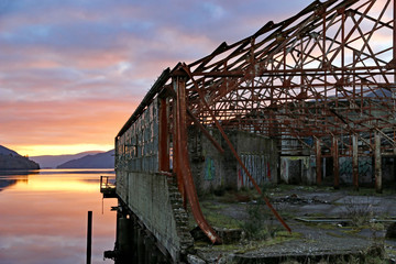 Derelict warehouse at Sunset over Loch Long, Scotland