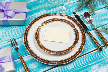 Holiday table setting on wooden table in lilac colors