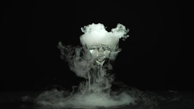 Drink in glass of martinis with the effect of dry ice