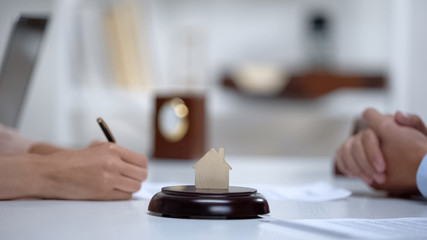Woman signing home purchase contract in lawyers office, insurance policy, deal