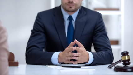 Confident lawyer attentively listening to client, legal problems solution