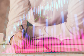 Financial trading chart double exposure with man desktop background.