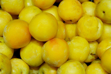 Background of yellow ripe plums. Close up photo