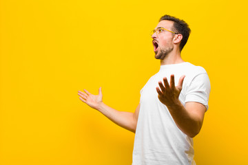 young handsome man performing opera or singing at a concert or show, feeling romantic, artistic and...