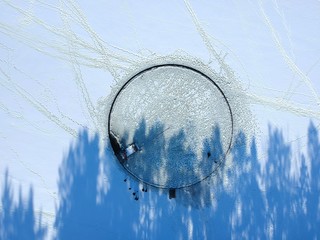 A large hole was cut out on a frozen lake. They made a big roundabout out of it, attaching the...