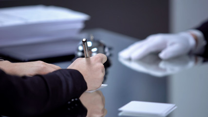 Business lady signing check, paying for service and hotel room, reception