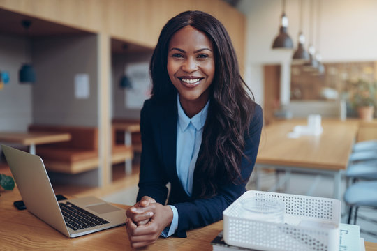 Smiling young African American businesswoman working in an offic