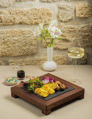 fried fish fillet with baby potatoes, fresh herbs and red onion slices