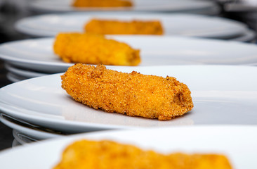 tasty fresh with a crust french fries, oblong breaded lies on a white plate