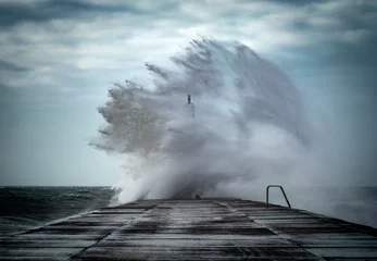 Fototapeten Strong winds create big waves that batter into Aberystwyth, Mid Wales sea front during the Storm season. © Rhodri