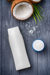 natural organic cosmetic advertising concept. cosmetic and cream bottle with open coconut