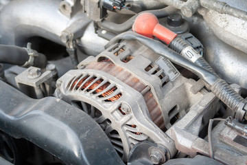 Alternator. Closeup detail of a Flat-four (boxer) car engine compartment under the open hood