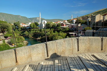 The uneven surface of the walkway accross the Old Bridge (Stari Most) with Koski Mehmed Pasha...