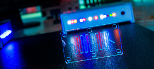microfluidic device Instrument that uses micro amounts of fluid on a microchip to do certain laboratory tests.