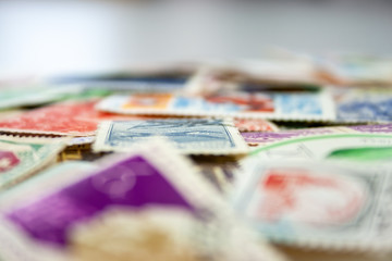 Closeup view on a variety of multi-colored postage stamps from different countries and years....