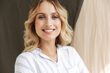 Image of young elegant blonde woman smiling at camera
