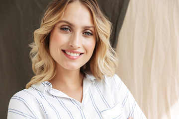 Image of beautiful elegant blonde woman smiling at camera