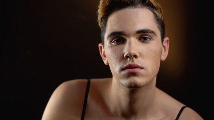 Fototapeta premium Seductive male transgender in female dress looking at camera, lgbt society