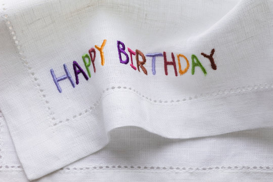 Napkin With The Words Happy Birthday Embroidered