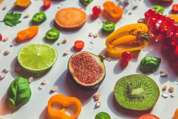 Raw healthy food collage - set fruit and vegetable slices on white background. 