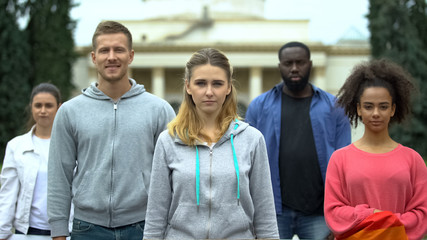 Group of people looking at camera, massive meeting for healthcare reform