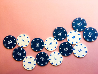 Poker chips on a pink background. Place for text.