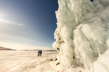 The girl on the background of the ice wall. Baikal, Russia