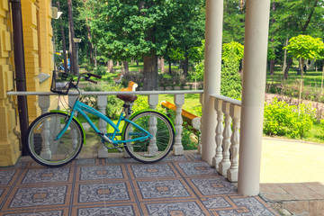 Fototapeta premium Bicycle stands on the porch of the house.