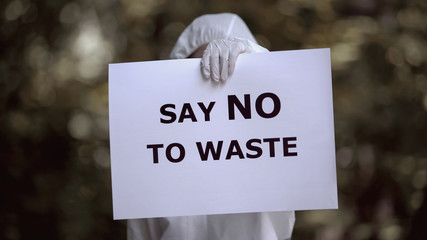 Say no to waste sign in biochemist hands, preventing environmental disaster