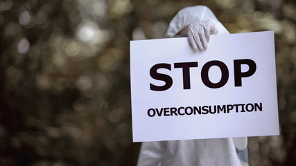 Stop overconsumption sign eco specialist holding, harming environment, pollution