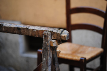Sedia impagliata con cavalletto di legno in primo piano
