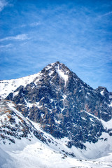 Snowy Lomnicky peak on a sunny day with a blue sky