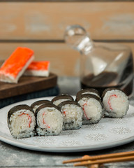 close up of kani maki crab stick sushi roll plate