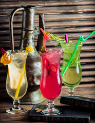 three glasses of fruit cocktails with pear, strawberry and tarragon
