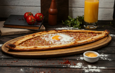 turkish breakfast pide flatbread topped with minced meat and egg