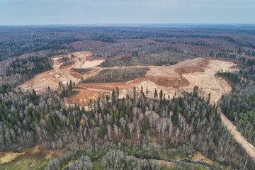 Aerial view with a drone. Landscape with autumn forest and sand quarry