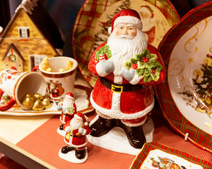 Three toy Santa Claus on the background of a colorful gift set.